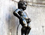 bronze statue of a chubby boy urinating into a fountain