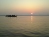 shimmer of rising sun on divine ganges, Varanasi, boat ride on holy ganges